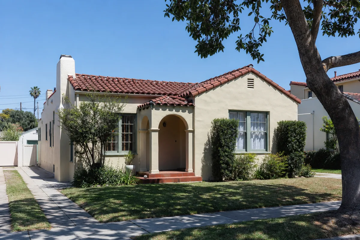 Quiet tree-lined Alhambra street of 1920s and 1930s Craftsman bungalows and small Spanish cottages with tidy lawns and mature trees