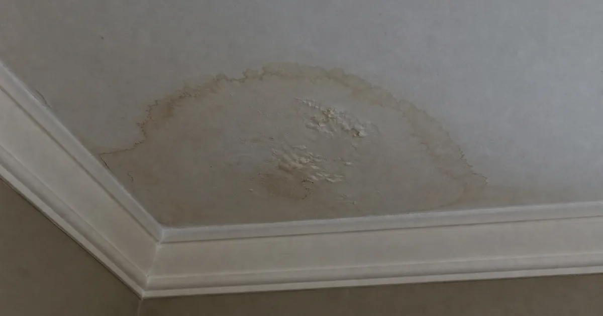 A brown water stain spreading across a family-room ceiling directly below an upstairs Aliso Viejo bathroom