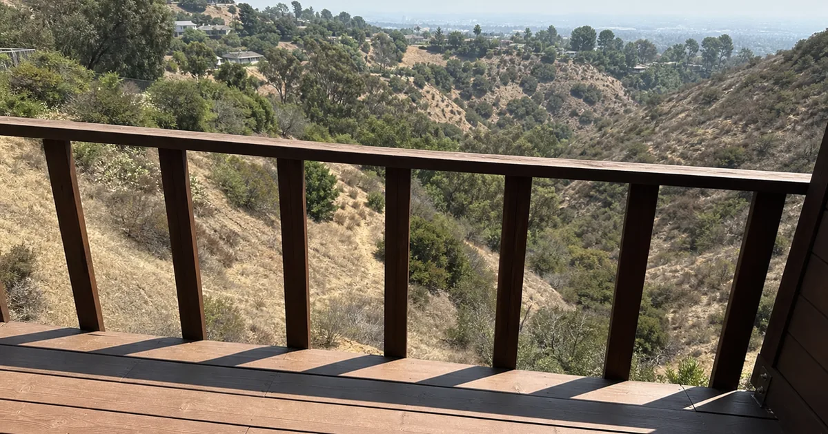 A hillside deck guard on a Chino Hills home with wide-spaced balusters overlooking a slope