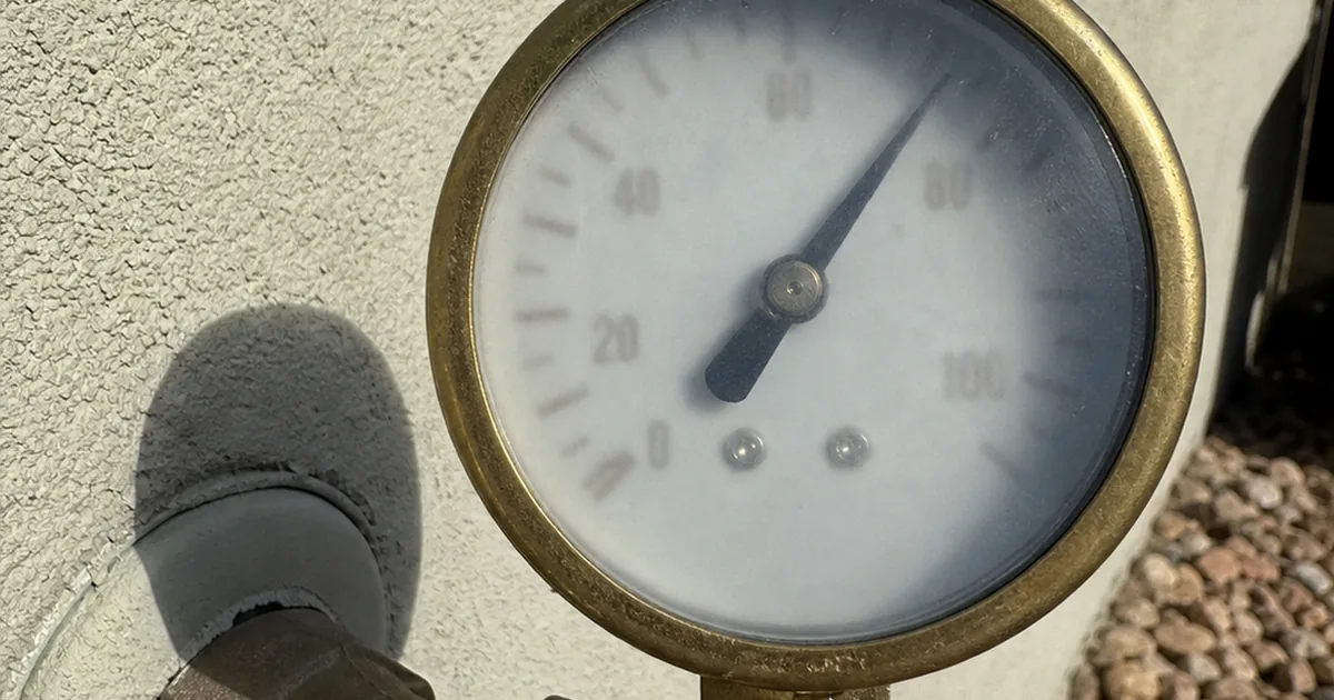 A pressure gauge on a Porter Ranch hose bib reading far above the normal range