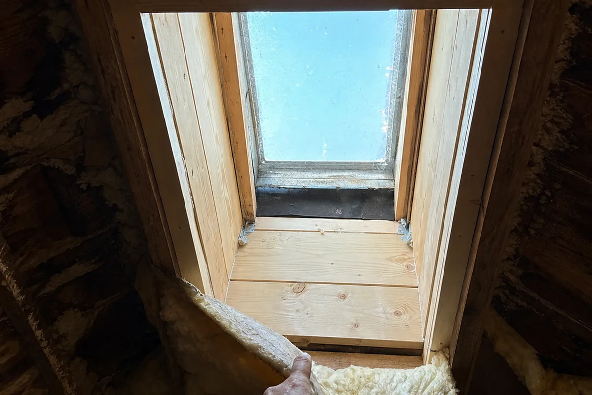 Looking up at a skylight shaft in an attic with properly doubled trimmer rafters and a correctly sized header framing the opening