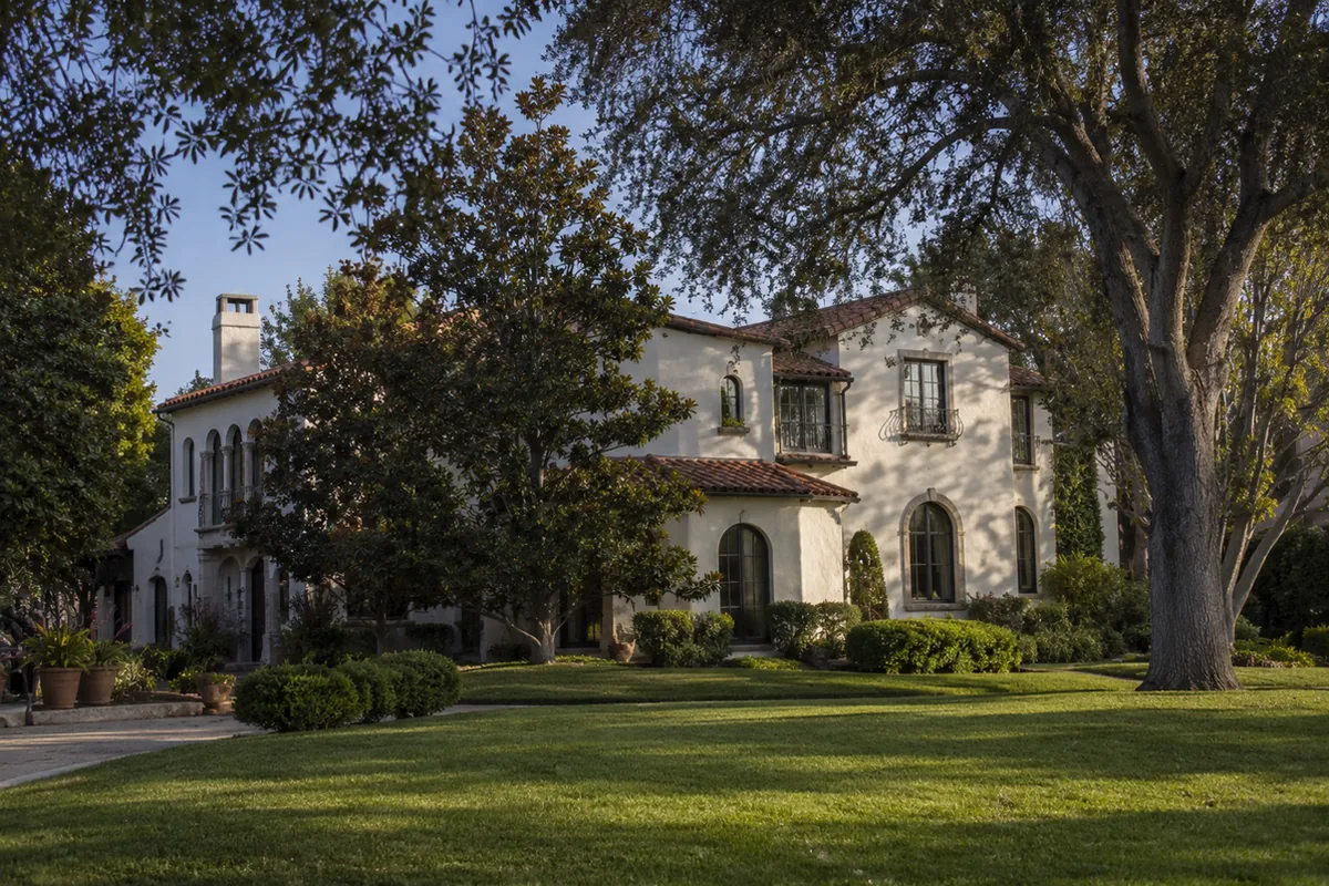 Large 1920s Spanish Colonial Revival estate in San Marino with cream stucco, a red clay tile roof, and mature oak and magnolia trees