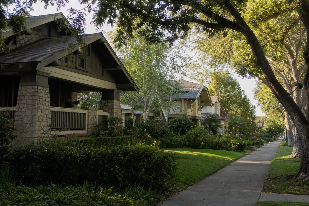 Quiet tree-lined South Pasadena street of early-1900s Craftsman bungalows with deep front porches and mature shade trees